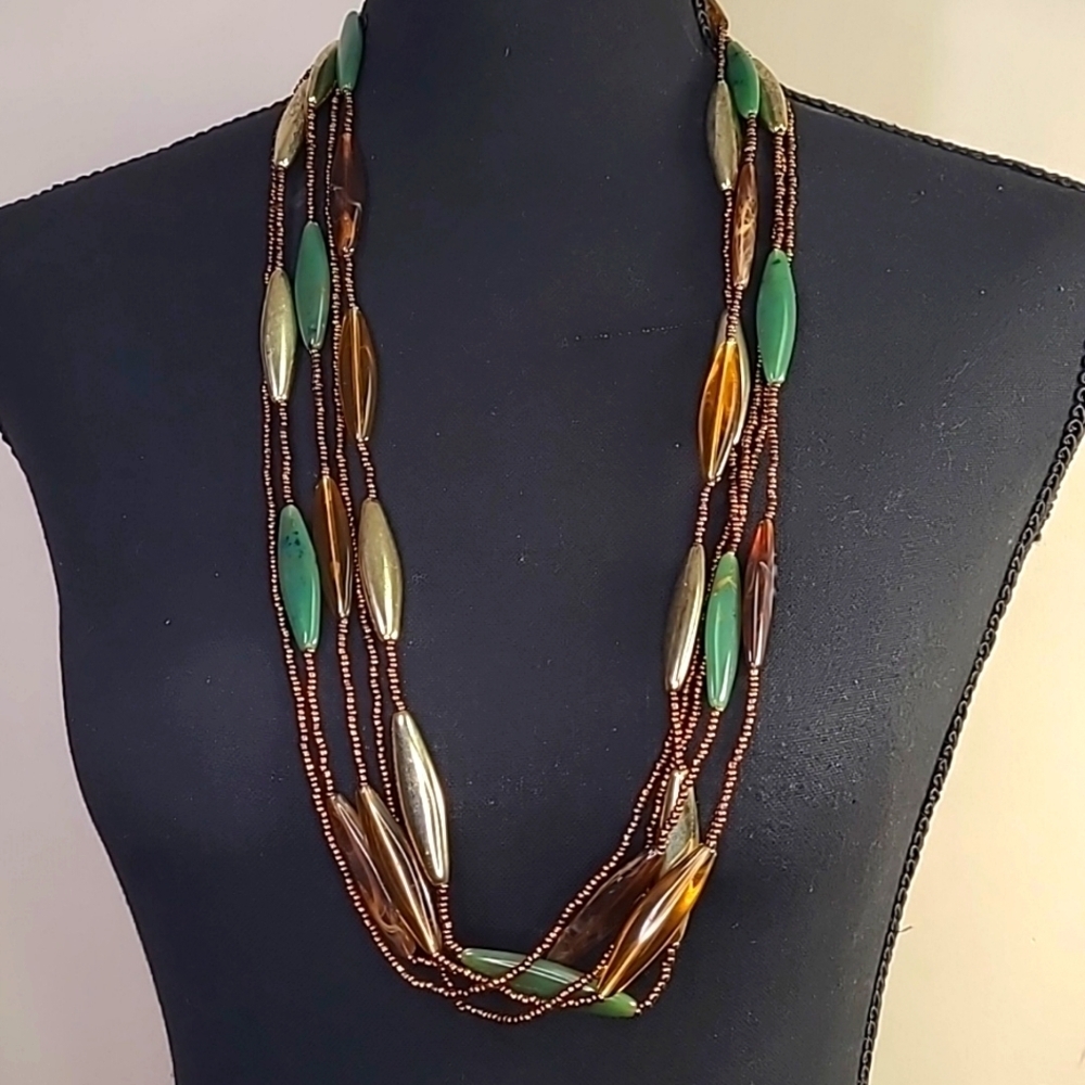 Small brown beads. Brown, gold and jade green beads. 31 inches.